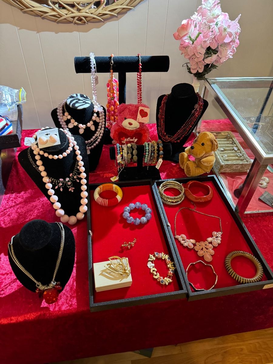 Table of costume jewelry on red velvet