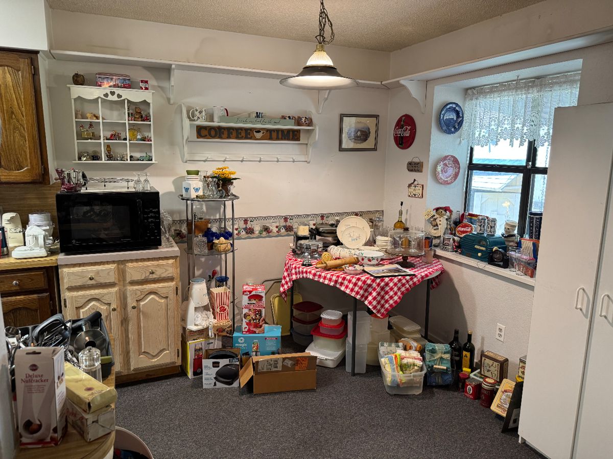 Vintage kitchen with checkered tablecloth and collectibles at a Burleson estate sale