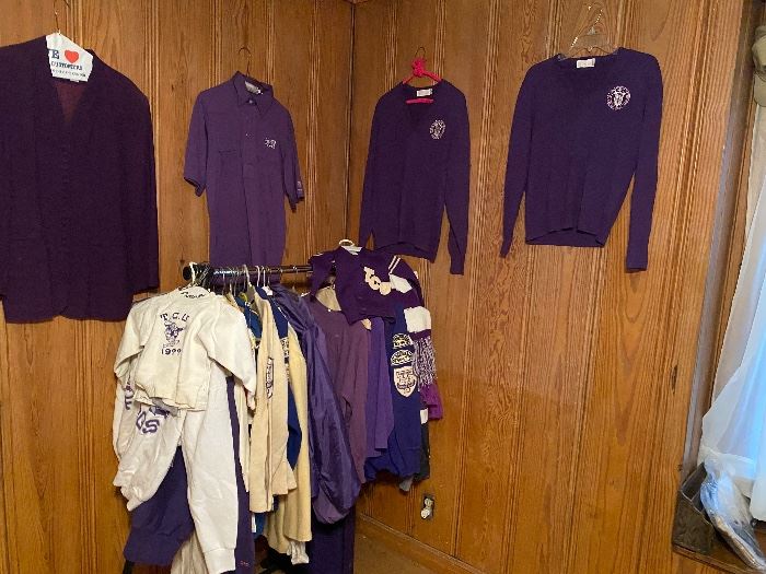 Vintage purple TCU sweaters and jackets on a wood wall