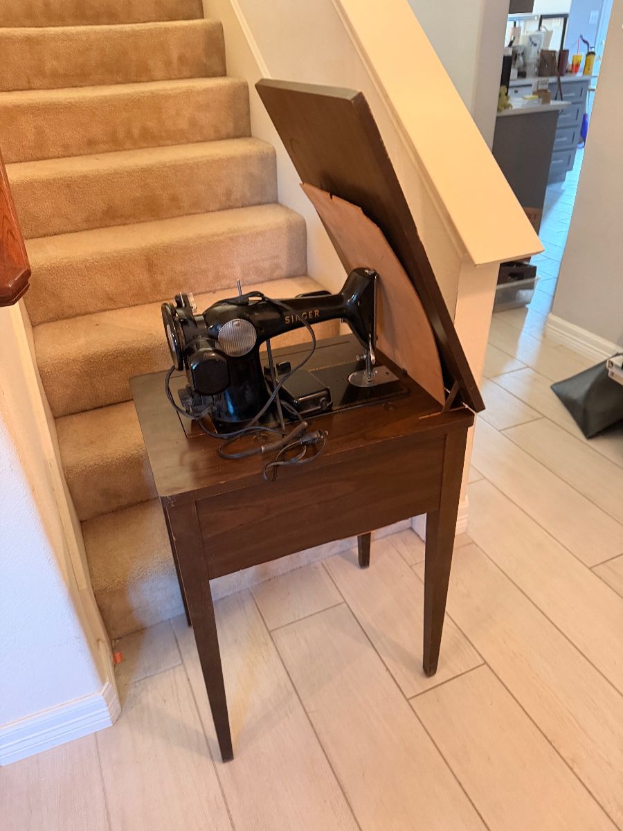 Vintage sewing machine in its wooden cabinet