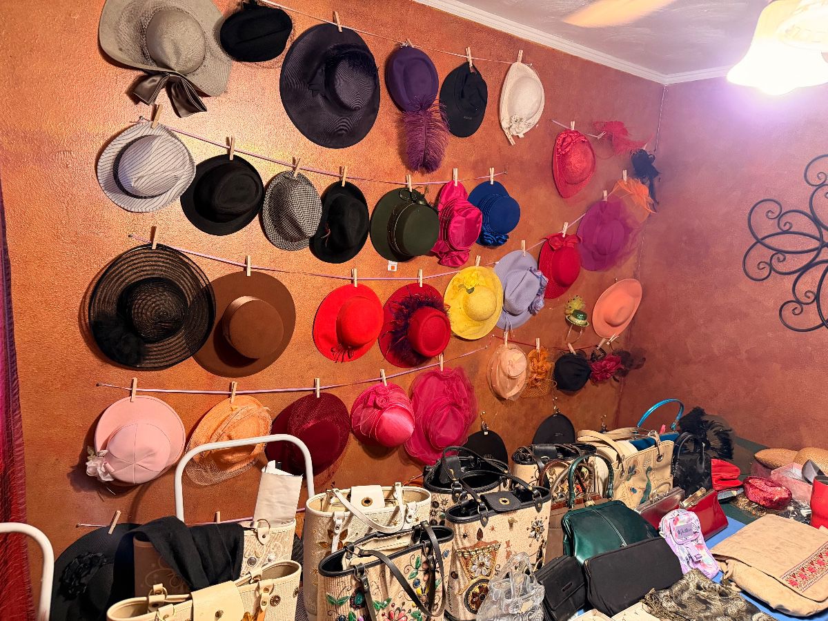 Wall display of custom made ladies hats at an Irving estate sale