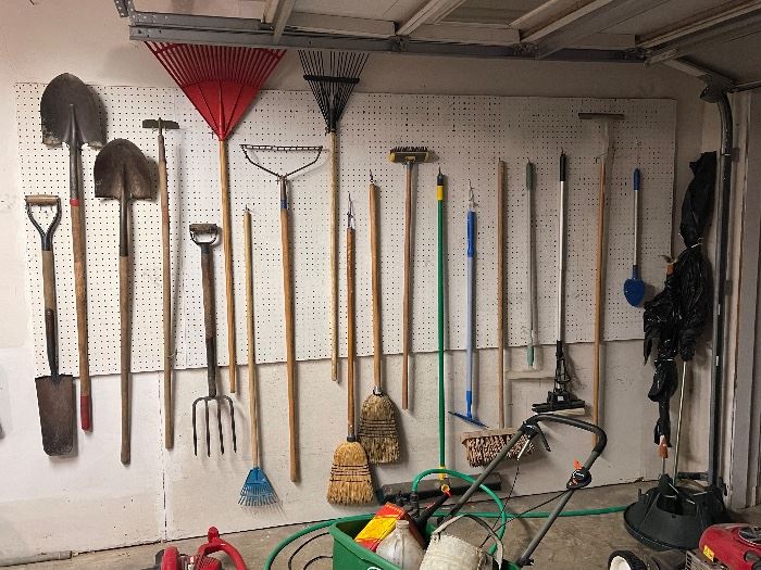 Wall of garden tools, rakes and shovels