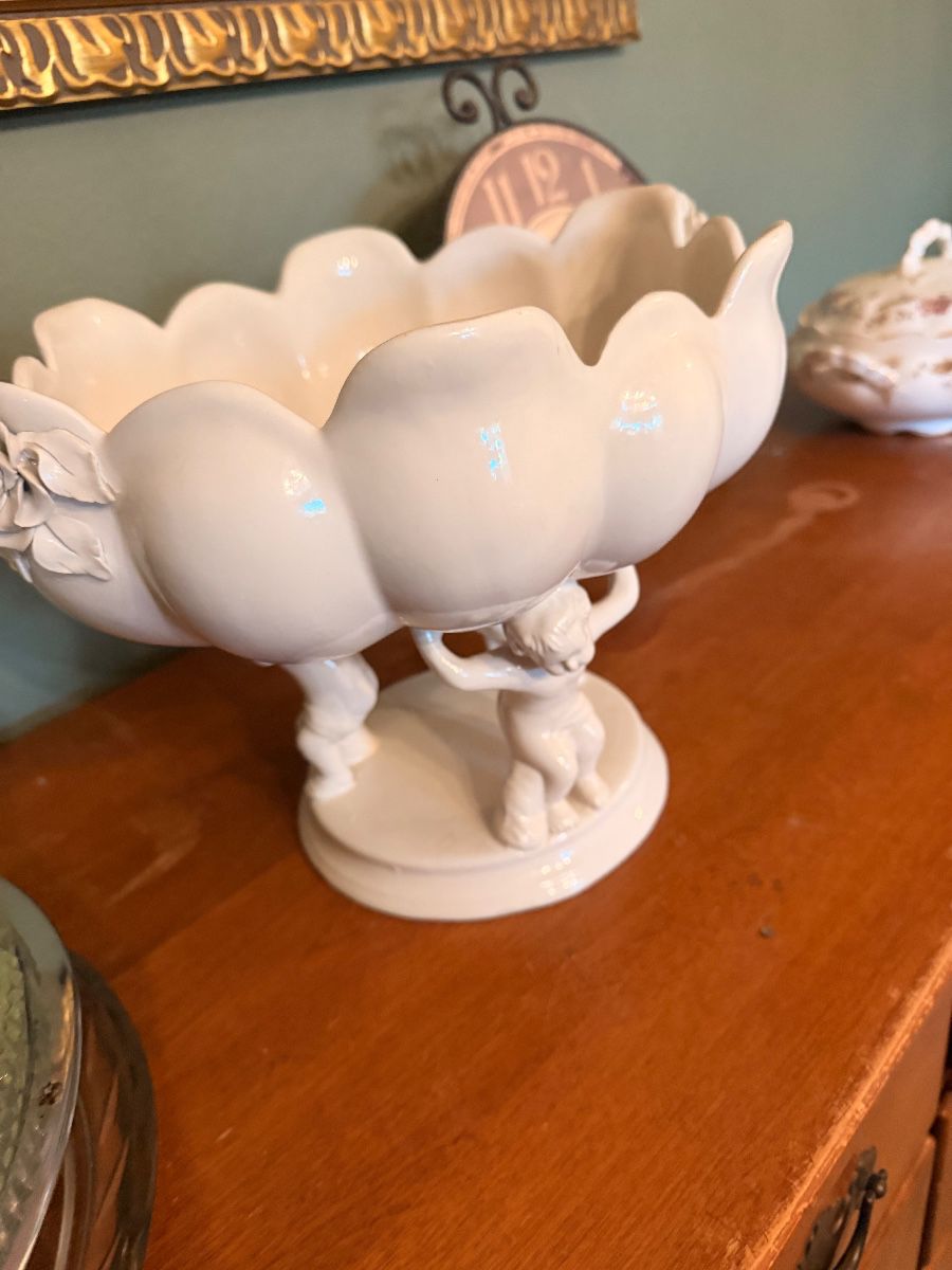 White milk glass compote with scalloped bowl and cherub pedestal base