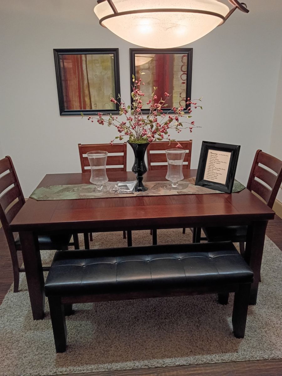 Wood dining table with matching bench and chairs
