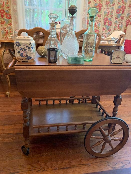 Wooden tea cart with decanters and a ginger jar