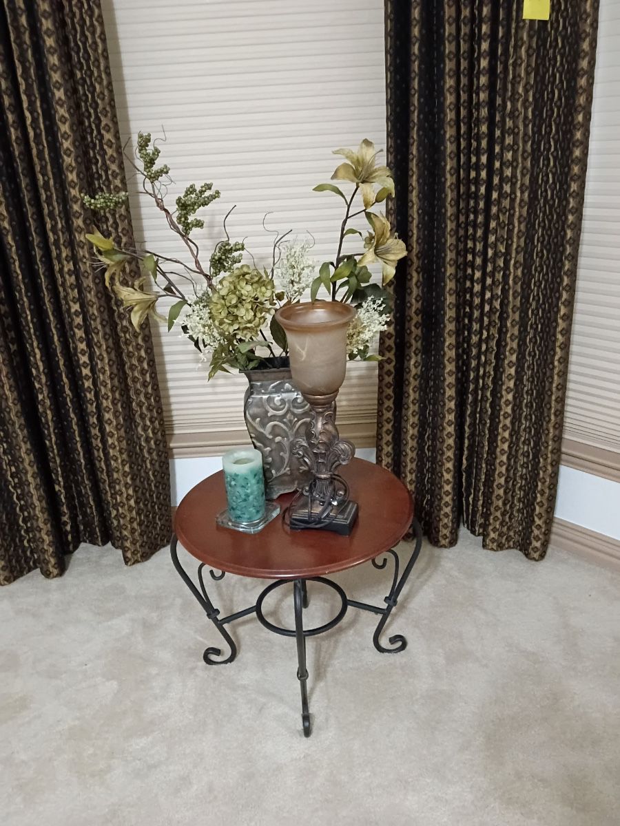 Wrought iron accent table with a floral arrangement