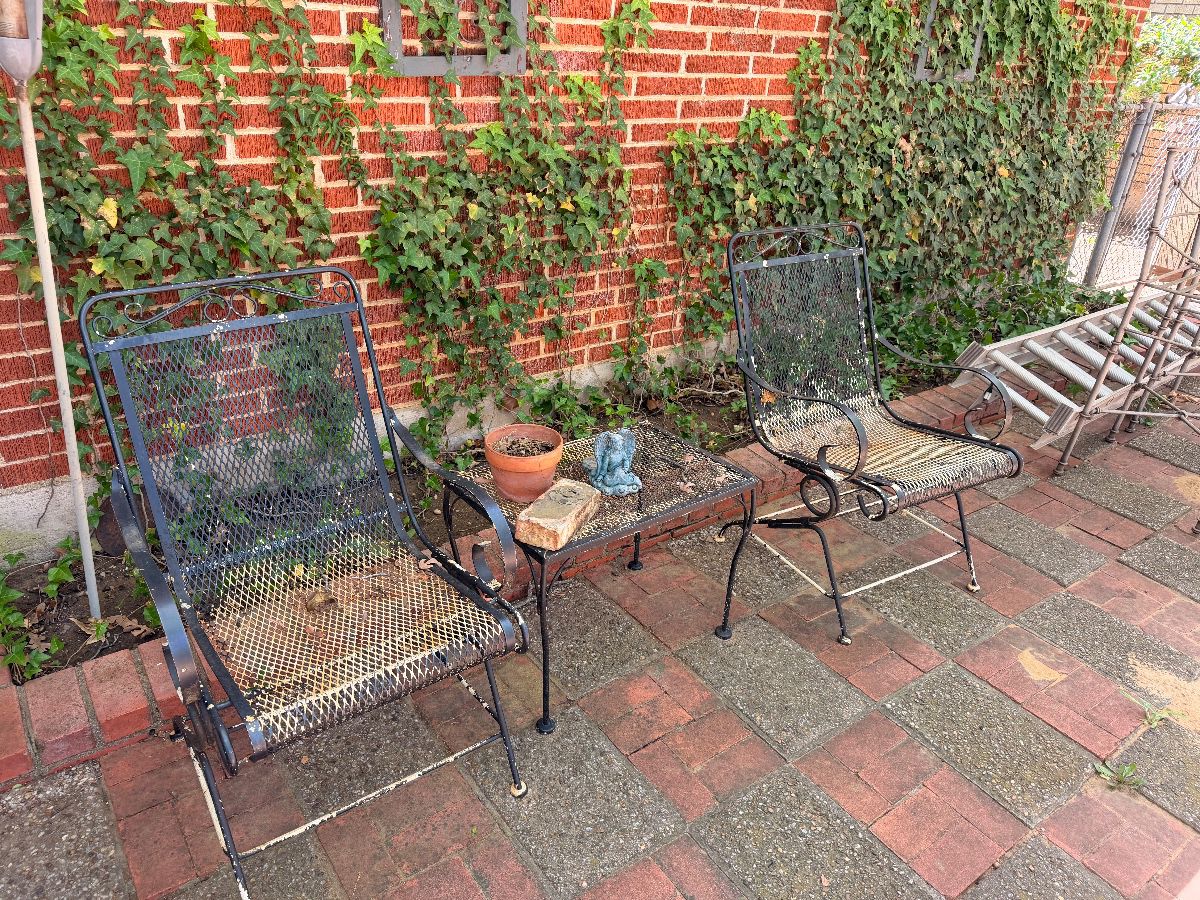 Wrought iron patio chairs on a brick patio