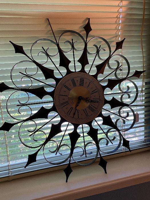 Wrought iron starburst wall clock at a Dallas estate sale