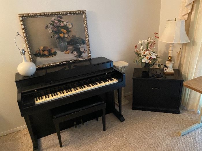 Wurlitzer piano with framed floral art